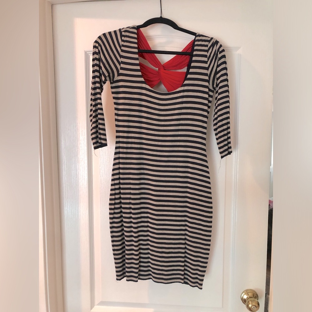 Thigh length dress with navy and khaki horizontal stripes and red bow on back.